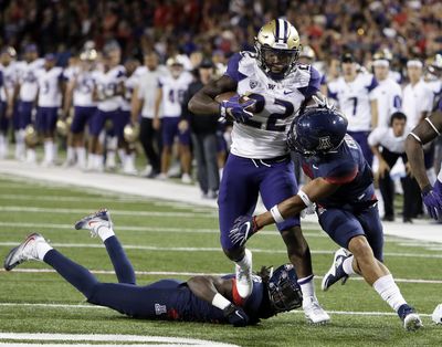 Washington running back Lavon Coleman (22) runs the ball for 24 yards in overtime during the Huskies’ overtime win over Arizona late Saturday night. (Rick Scuteri / Associated Press)