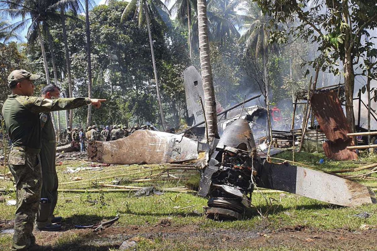 Parts of a Lockheed C-130 Hercules plane are seen at the crash site in Patikul town, Sulu province, southern Philippines on Sunday.  (HOGP)