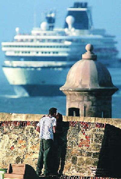 
A couple kisses by the seaside walls of El Morro Fort, as an incoming cruise ship passes by in Old San, Puerto Rico. 
 (Associated Press / The Spokesman-Review)