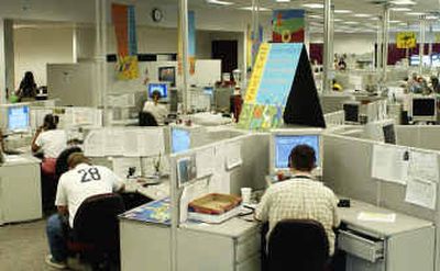 
Employees at the Center Partners call center in Idaho Falls, Idaho, work for a starting wage of $8 an hour. 
 (Associated Press / The Spokesman-Review)