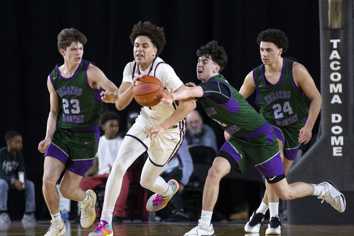 Mt. Spokane’s Jaden Ghoreishi steals the ball between Edmonds-Woodway’s DJ Karl, left, and Dre Simonsen during Friday’s State 3A semifinal at the Tacoma Dome. Edmonds-Woodway won 41-34. (Patrick Hagerty/For The Spokesman-Review)