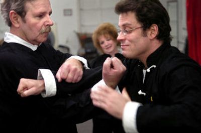 
Instructor David Toutonghi, right, demonstrates for Dwight and Anna Henderson how a particular kung fu move could be used defensively during a class at Kung Fu for Life. 
 (HOLLY PICKETT PHOTOS / The Spokesman-Review)