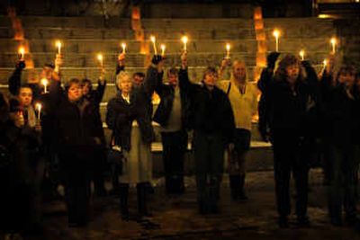Participants at a World AIDS Day vigil in Spokane lift their candles as a sign of hope during a celebration and remembrance at the Northwest Museum of Arts and Culture on Wednesday evening. People living with HIV or AIDS, family and friends, activists, and community members gathered to support each other and remember those who have died from the disease.
(Holly Pickett / The Spokesman-Review)