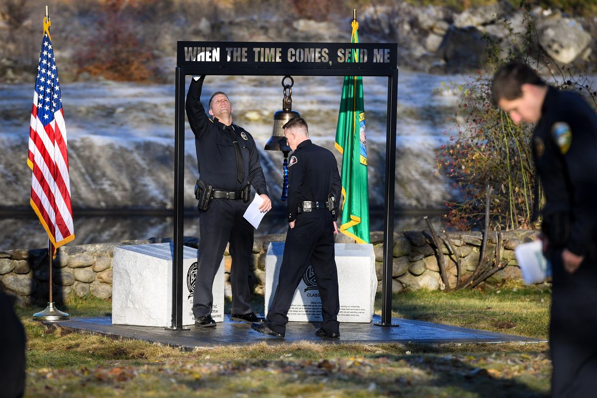 Matthew Costello, Kalispel Tribal Public Saftey Department, left, and Charles Hamlin III, Yakima Police Department, tidy up around the new Memorial to Fallen Law Enforcement Officer in Washington State, Thurday, Nov. 21, 2019, at the Spokane Police Regional Training Center. The pair are members of the Basic Law Enforcement Academy Class 792. The 32 members assembled the memorial as part of their class project and held a dedication ceremony on Thursday. (Dan Pelle / The Spokesman-Review)
