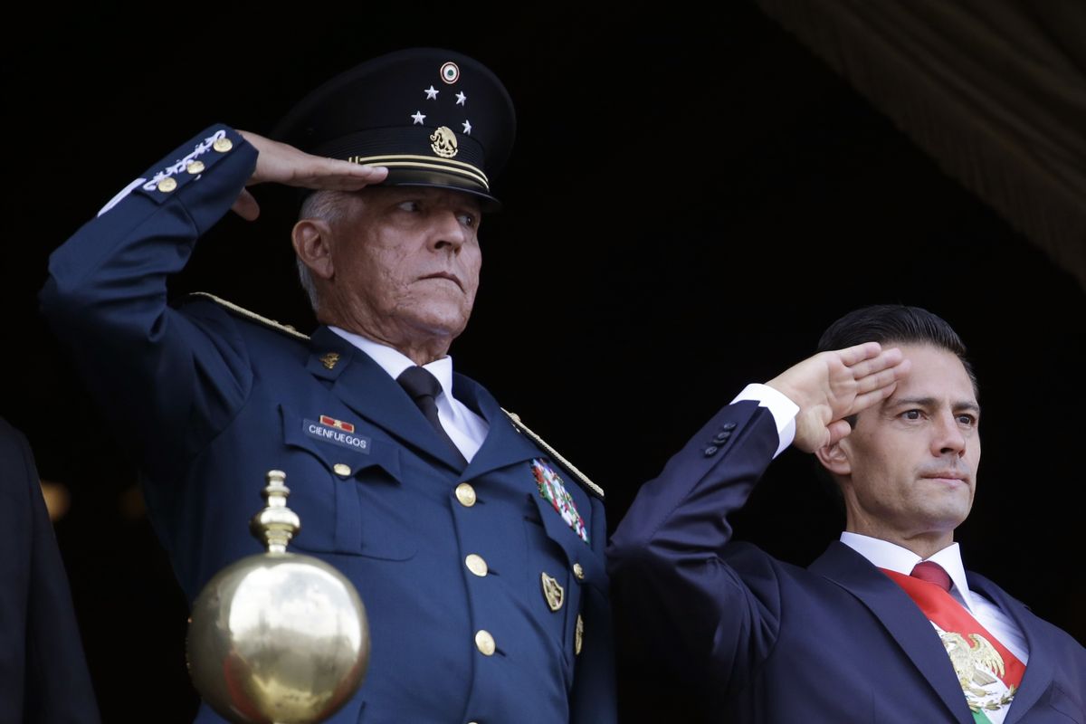 FILE - In this Sept. 16, 2016 file photo, Defense Secretary Gen. Salvador Cienfuegos, left, and Mexico