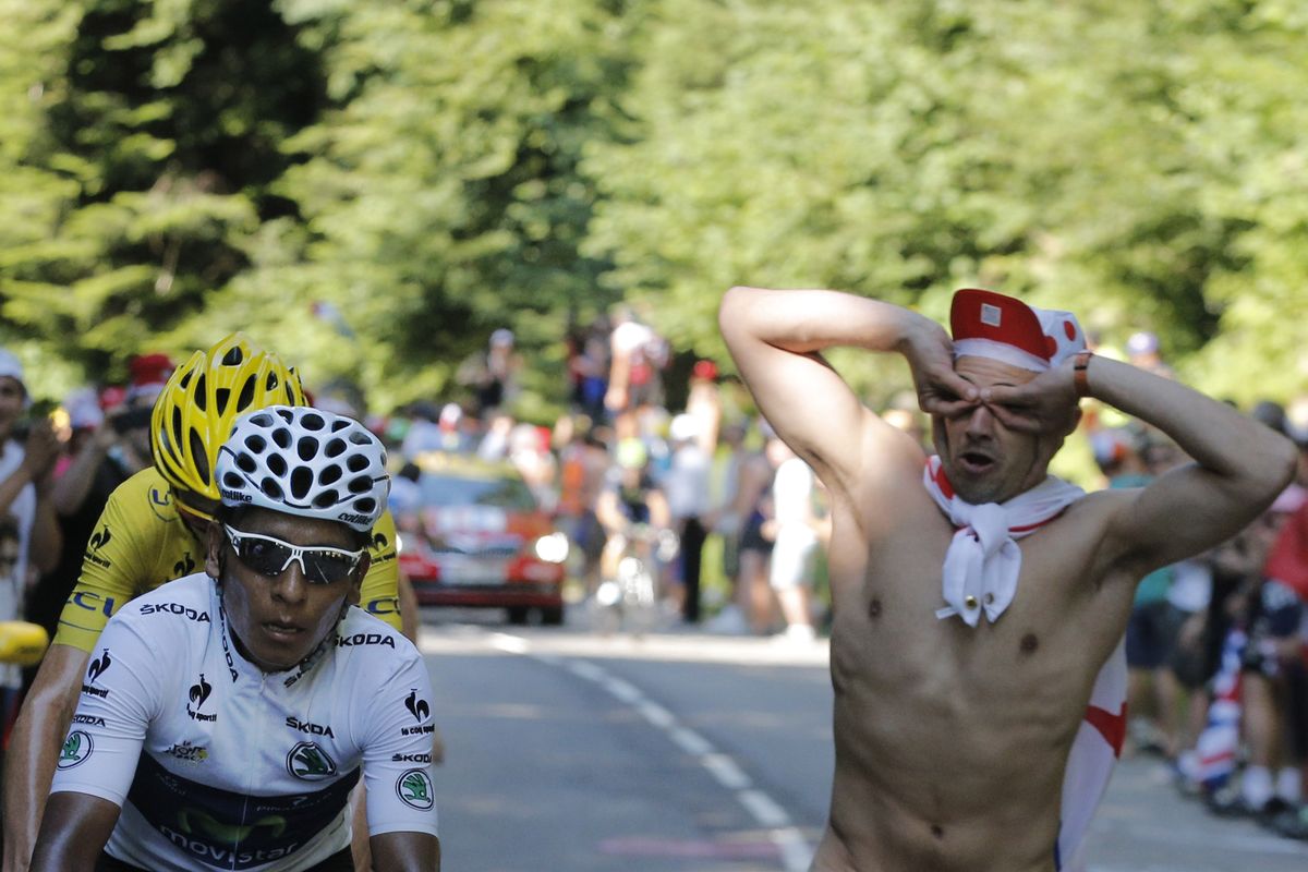 A naked spectator runs alongside stage winner Nairo Quintana of Colombia during the 20th stage of the Tour de France on Saturday. (Associated Press)