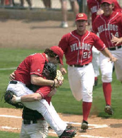 
Georgia pitcher Will Startup, left, hitches a ride with catcher Clint Sammons after the Bulldogs eliminated the Georgia Tech Yellow Jackets on Saturday. 
 (Associated Press / The Spokesman-Review)