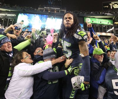 Seattle defensive back Richard Sherman celebrates with fans after the Seahawks topped San Francisco in the NFC Championship game.