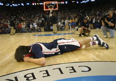 Gonzaga forward Adam Morrison collapses to the floor after UCLA eliminated the Bulldogs by scoring the game's final 11 points.
 (Brian Plonka / The Spokesman-Review)