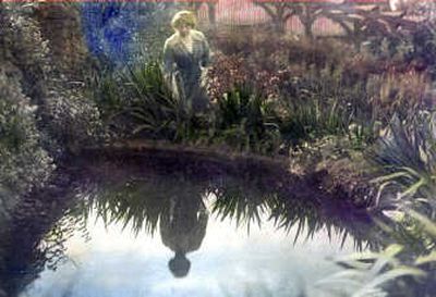 
Bertha Turner, a former owner of the Moore-Turner Heritage Gardens, is shown gazing into the reflection pool in this hand-tinted photograph from the early 1900s.
 (The Spokesman-Review)