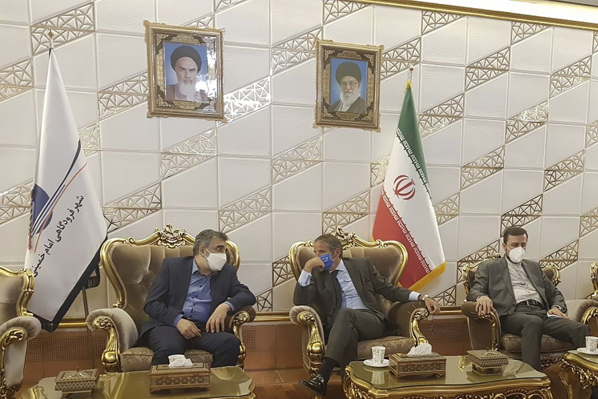 Director General of International Atomic Energy Agency, IAEA, Rafael Mariano Grossi, center, speaks with Deputy Head of the Atomic Energy Organization of Iran, Behrouz Kamalvandi, left, upon his arrival at Tehran Imam Khomeini International Airport, Iran, Saturday, Sept. 11, 2021. Iran's envoy to the IAEA, Kazem Gharibabadi, sits at right.  (HOGP)