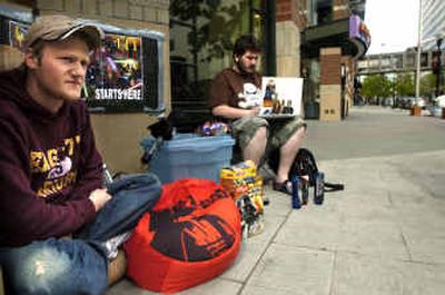 Joe Lack, left, and Rob Paine were first in line Tuesday at River Park Square, where they have been waiting with blankets,