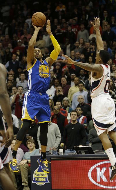 Andre Iguodala hits a 3-pointer at the buzzer to give Golden State a 101-100 win over Atlanta. (Associated Press)