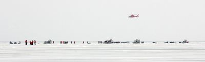 A helicopter flies over fishermen stranded on a slab of ice about 8 miles wide that broke free and floated away from the Ohio shoreline of Lake Erie on Saturday.  (Associated Press / The Spokesman-Review)