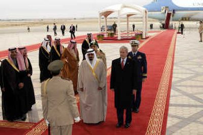 
President Bush received the red carpet treatment Monday from King Abdullah, center, at King Khalid International Airport north of Riyadh.
 (The Spokesman-Review)