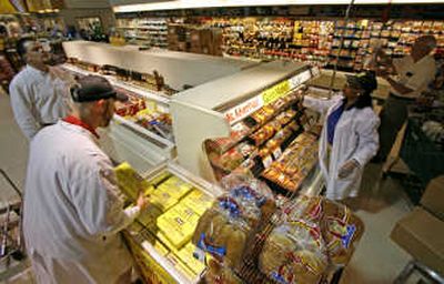 
Shirley Jones, right, helps stock a display of picnic meats and products at a Ukrop's Supermarket in Richmond, Va. Associated Press
 (Associated Press / The Spokesman-Review)
