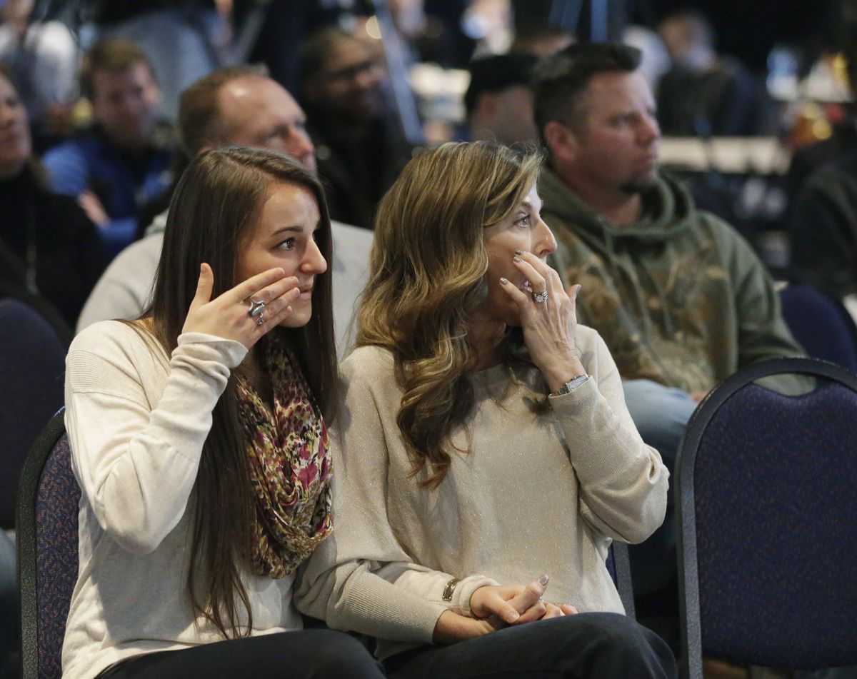 Tina Pagano, right, and her daughter Taylor Pagano, listen as Colts head coach Chuck Pagano speaks during a news conference on Monday as he returned to the team after undergoing successful leukemia treatment. (Associated Press)