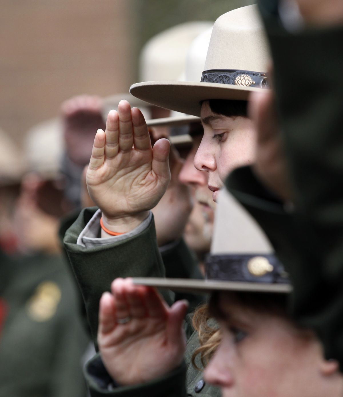 Park rangers and law enforcement personnel salute as the casket bearing the remains of Mount Rainier National Park Ranger Margaret Anderson is brought into a memorial service today in Tacoma. Anderson, a 34-year-old mother of two young girls, was shot and killed after setting up a roadblock to stop a vehicle that blew through a checkpoint on the road to the park