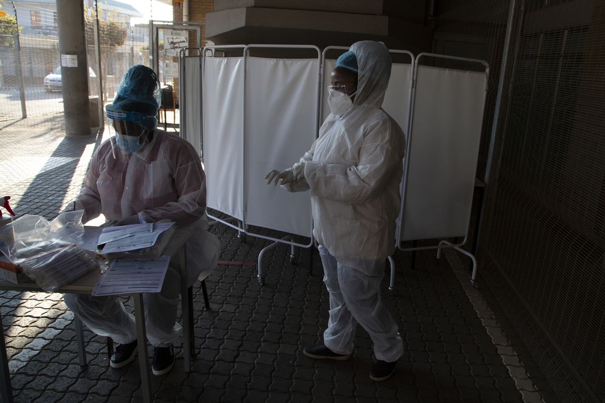 In this Tuesday, June 22, 2021 photo, healthcare workers prepare to test patients for COVID-19 at the Lancet Laboratories in Johannesburg. Driven by the delta variant, a new wave of COVID-19 is sweeping across the African continent where new cases, hospital admissions, and deaths are increasing.  (Denis Farrell)
