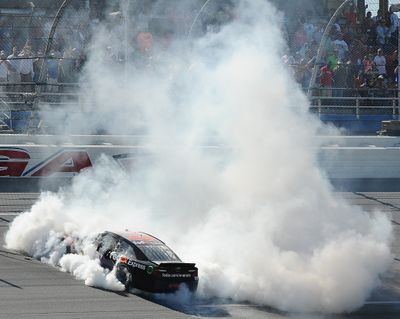 Denny Hamlin does a burnout after winning at Talladega. (Associated Press)