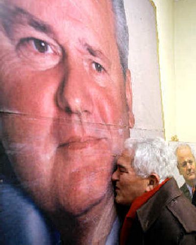 
A supporter of Slobodan Milosevic kisses a poster of the former Serbian leader after news that he was found dead in jail Saturday. 
 (Associated Press / The Spokesman-Review)