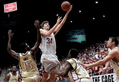 
Washington State center Robbie Cowgill shoots over the University of Washington's defense during the Cougars' Pac-10 victory in Pullman on Saturday. 
 (Christopher Onstott / The Spokesman-Review)