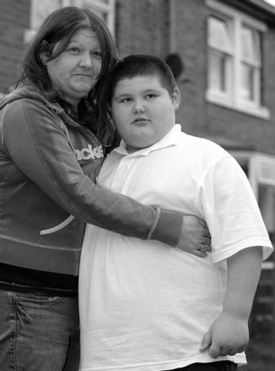 
Eight-year-old Connor McCreaddie, right,  who weighs 218 pounds,  and his mother Nicola McKeown, left, stand outside their home in Wallsend,  England, on Monday. 
 (Associated Press / The Spokesman-Review)