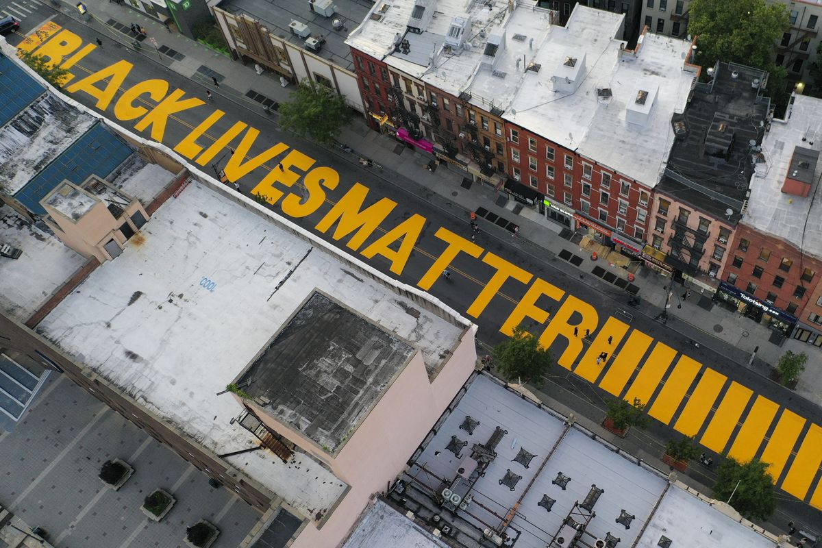 In this June 15, 2020, photo, a sign reading "Black Lives Matter" is painted in orange on Fulton Street in the Brooklyn borough of New York. More Americans now say police brutality is a serious problem that too often goes undisciplined and unequally targets black Americans. A poll from The Associated Press-NORC Center for Public Affairs Research shows a dramatic shift in the nation’s public opinion on policing and race.  (John Minchillo)