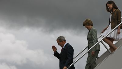 President Bush salutes as he arrives with first lady Laura Bush and daughter Barbara Bush to make remarks to military personnel at Eielson Air Force Base, Alaska, on Monday.  (Associated Press / The Spokesman-Review)