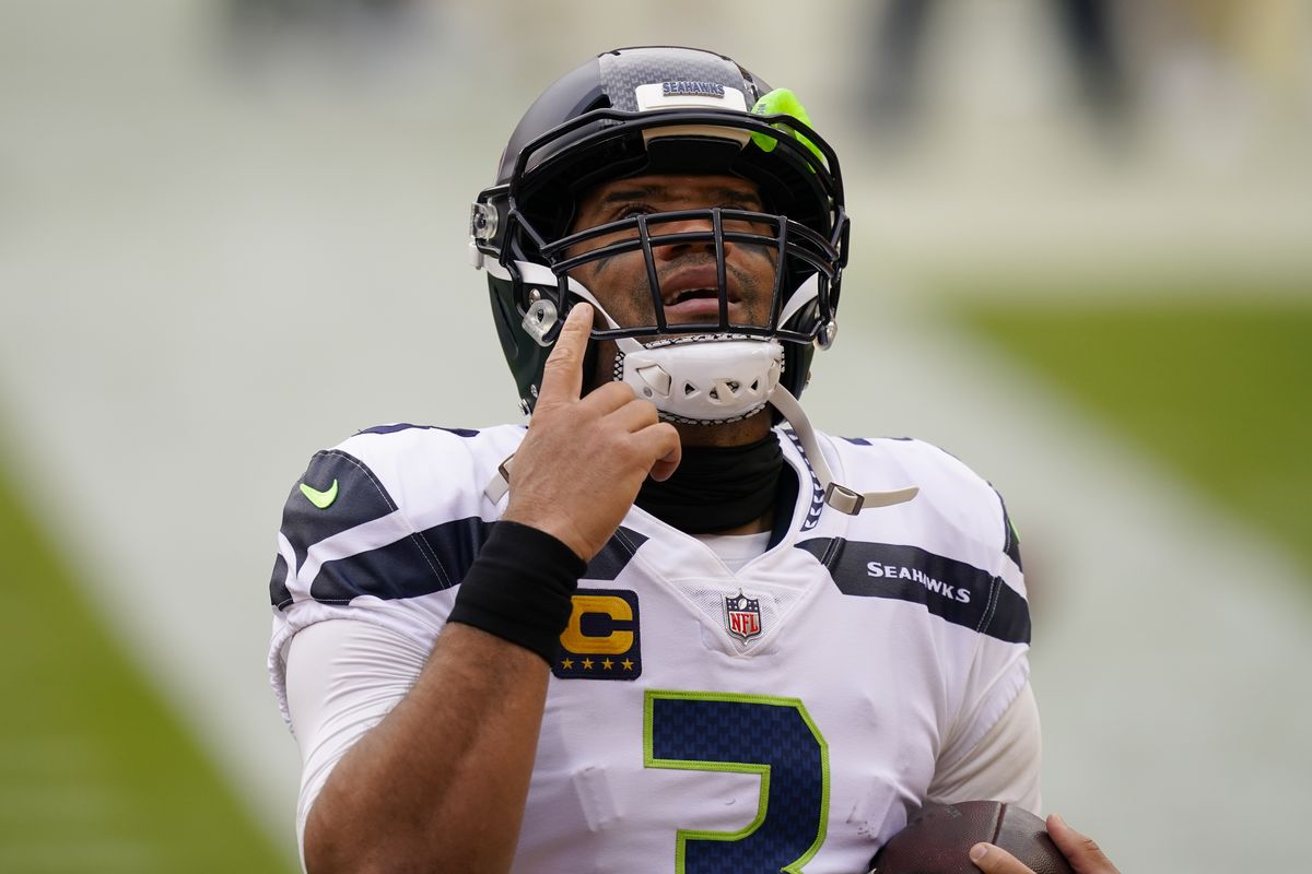 Seattle Seahawks quarterback Russell Wilson (3) points upwards before the start of the first half of an NFL football game against the Washington Football Team, Sunday, Dec. 20, 2020, in Landover, Md.  (Andrew Harnik)