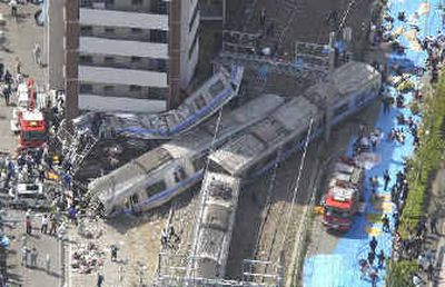 
A seven-car commuter train is seen after it derailed in Amagasaki, western Japan, today. 
 (Associated Press / The Spokesman-Review)