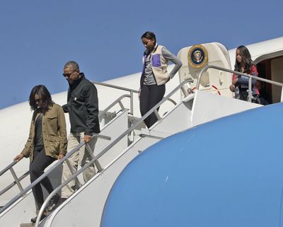 President Barack Obama and first lady Michelle Obama, followed by daughters Sasha and Malia, arrive Thursday on Air Force One at San Carlos de Bariloche in Bariloche, Argentina. (Pablo Martinez Monsivais / Associated Press)