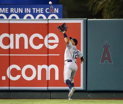 Mariners center fielder Leonys Martin reaches back to catch a fly ball hit by Ji-Man Choi of the Angels. (Reed Saxon / Associated Press)