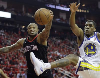 Houston forward P.J. Tucker, left, and Golden State forward Kevon Looney chase a rebound during the first half in Game 2 of the NBA Western Conference Finals on Wednesday in Houston. (David J. Phillip / AP)