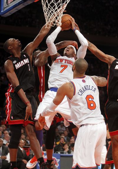 New York Knicks’ Carmelo Anthony (7) muscled his way to a double-double in Friday night’s victory over Miami at MSG. (Associated Press)