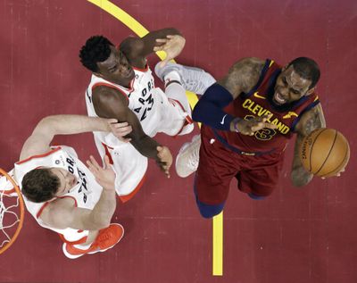Toronto Raptors’ Jakob Poeltl, left, and Pascal Siakam defend against Cleveland Cavaliers’ LeBron James during the first half of an NBA basketball game Wednesday, March 21, 2018, in Cleveland. (Tony Dejak / Associated Press)