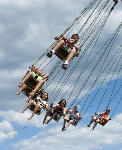 A group of teen-agers take a swing on The Yoyo ride at North Idaho Fair & Rodeo at Kootenai County Fairgrounds on Thursday, August 25, 2016. A child was injured on the “Firehouse” slide Friday night, according to her mother. The ride has been shut down. (Kathy Plonka / The Spokesman-Review)