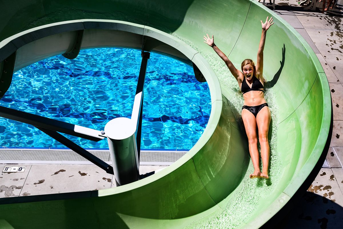Allie Lafferty, 17, has some fun heading down the curly slide Monday at Comstock Pool. (Colin Mulvany / The Spokesman-Review)