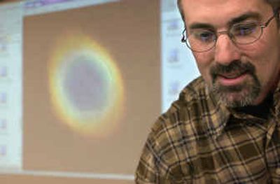 
Coeur d'Alene High School science teacher Tim Burnside used EXCEL grant money to purchase a light projector as a teaching tool. 
 (The Spokesman-Review)