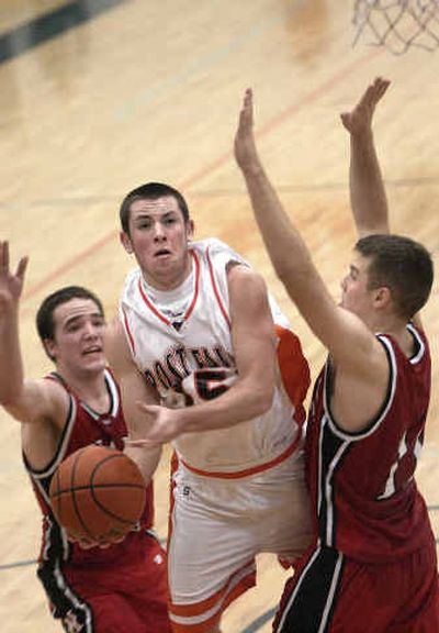 
Nick Cuchessi  of Post Falls splits Moscow's defenders and is fouled while attempting a scoop shot in Thursday's Inland Empire League game.
 (Tom Davenport/ / The Spokesman-Review)