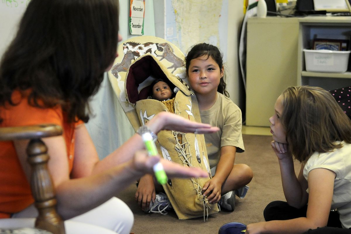 Holmes Elementary School fourth-grader and Spokane Tribe member Patty Hill, 9, brought her sister’s baby board to Betsy Weigle’s class on Tuesday for a lesson about Native Americans. The class included an Internet conference with students in South Carolina. (Dan Pelle / The Spokesman-Review)