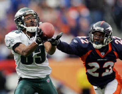 
Broncos cornerback Domonique Foxworth, right, gets a hand on the ball and prevents a catch by Eagles wide receiver Greg Lewis during second-quarter action at Invesco Field.
 (Associated Press / The Spokesman-Review)