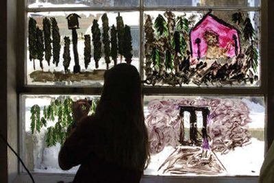 
Southside Christian student Erin Hagerty paints a forest scene on the school windows from the C.S. Lewis novel 
