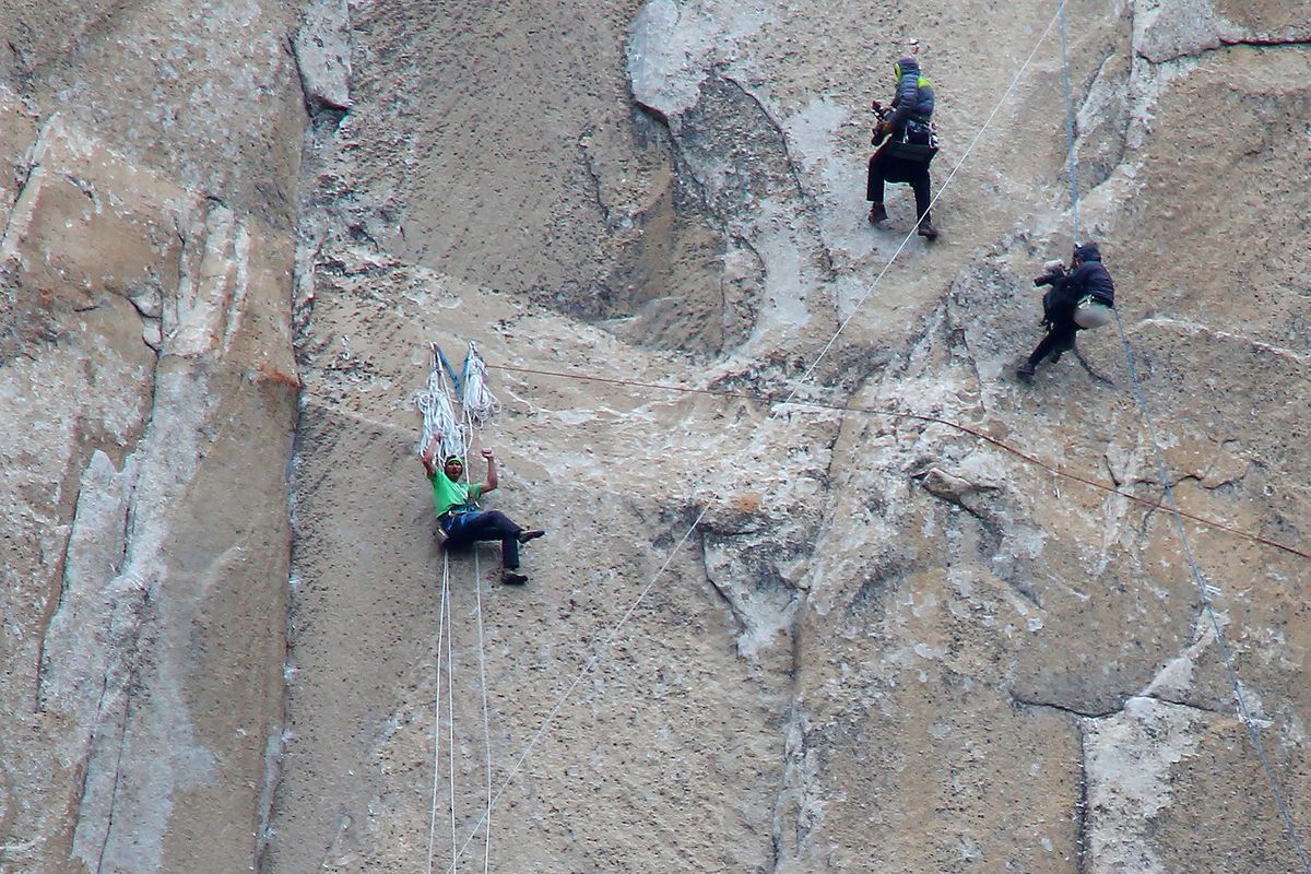 Kevin Jorgeson, left, celebrates finishing Pitch 15, one of most challenging of 32 such pitches on Dawn Wall climb, while two cameramen record moment in Yosemite.
