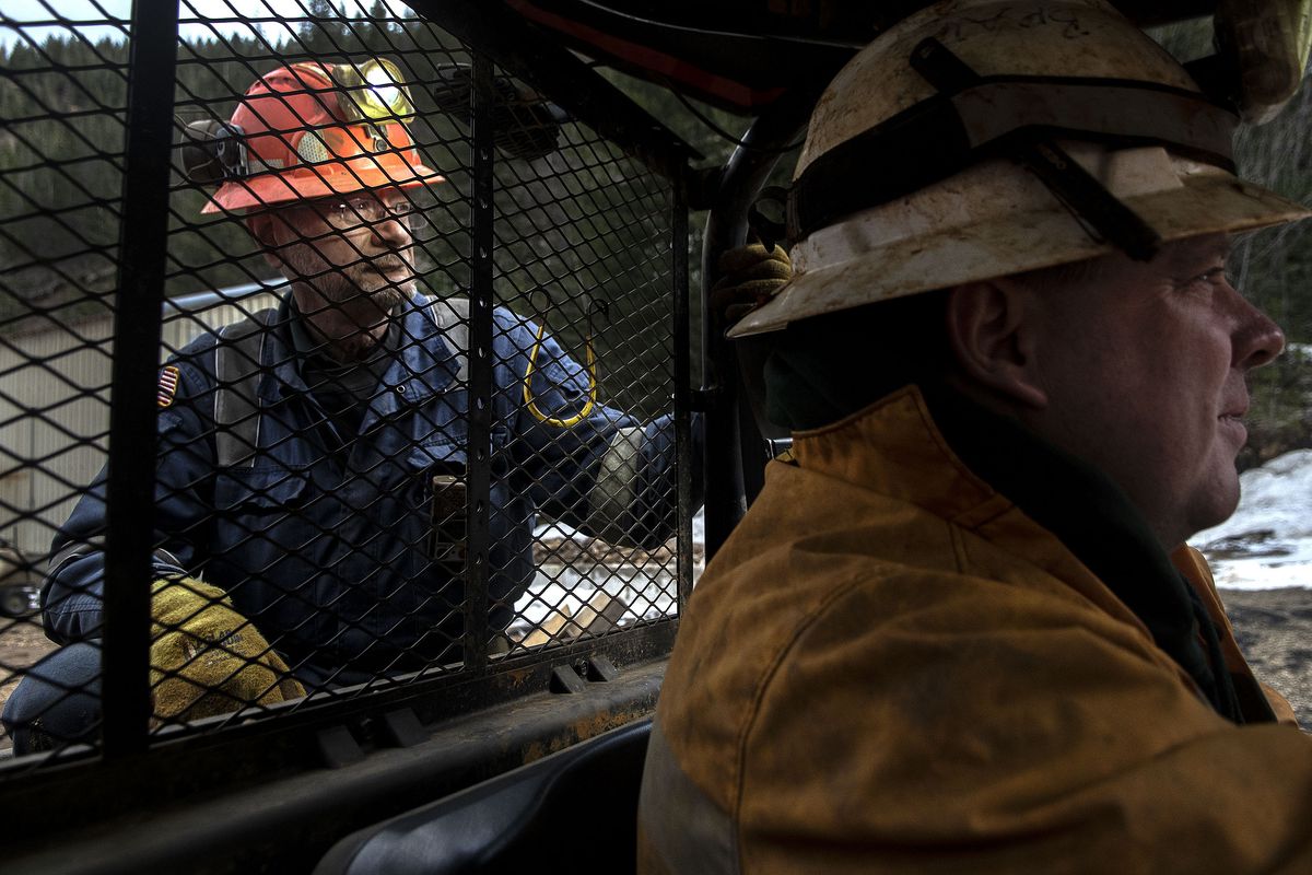 Mike Okuniewicz, mine safety consultant, left and Bradley Barnett, VP of sustainability ride an ATV into Bunker Hill Mine in Wardner, Idaho on Tuesday, March 30, 2021. New investors are using a more environmentally friendly method as they reopen the mine.  (Kathy Plonka/The Spokesman-Review)