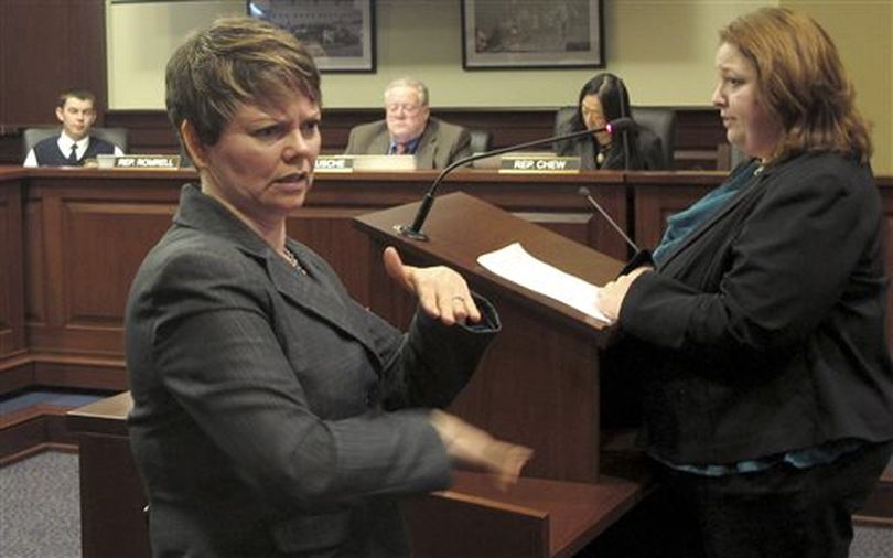 Holly Thomas-Mowery, left, translates the testimony of a woman, right, into sign language in front of the House Health and Welfare Committee on Wednesday. The committee went on to approve legislation that would create a state licensing process for sign language interpreters. (AP / Kimberlee Kruesi)