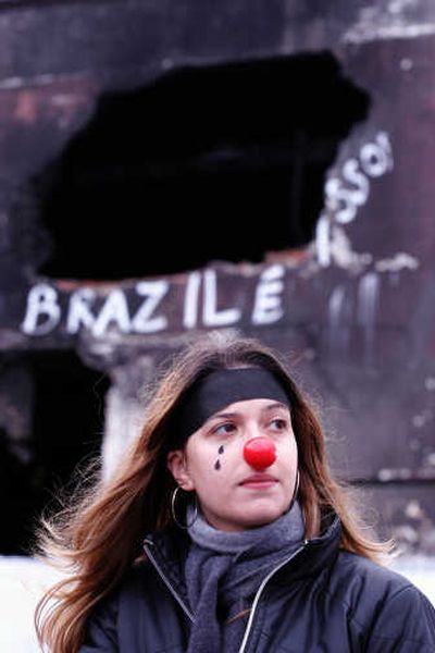 
A demonstrator stands Sunday near where a July 18 crash killed 199 people. Associated Press
 (Associated Press / The Spokesman-Review)