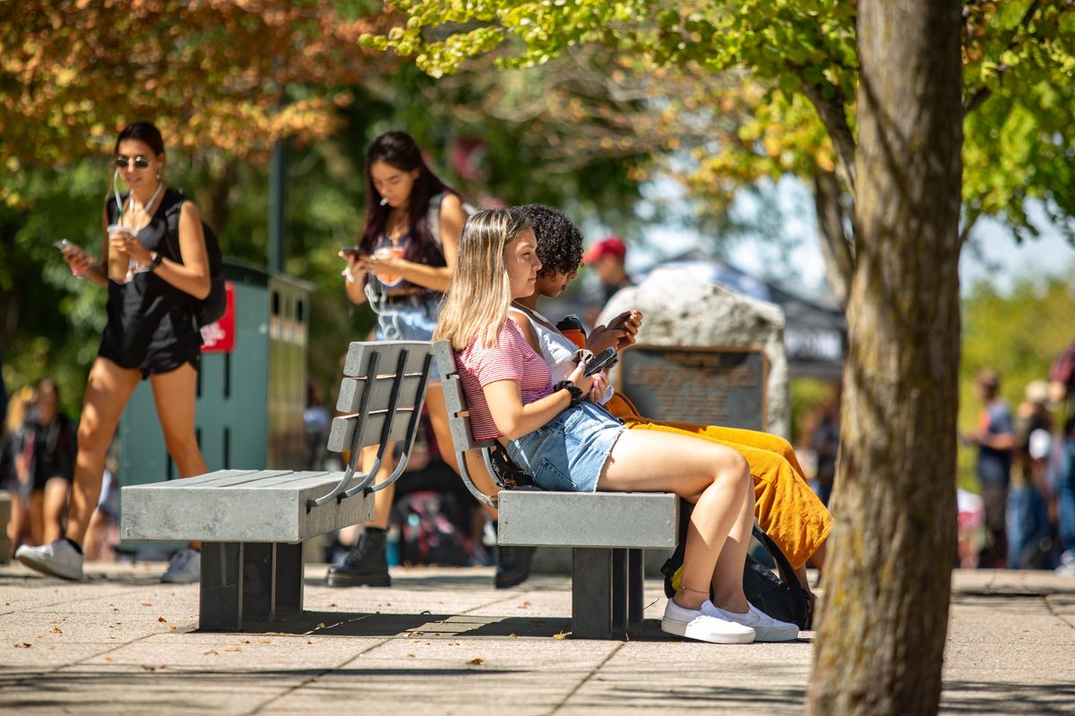 Students sit on benches on the Glen Terrell Mall in 2019 on the Washington State University main campus in Pullman. WSU’s new president Betsy Cantwell outlined her vision for the future last week in Spokane. (THE SPOKESMAN-REVIEW)