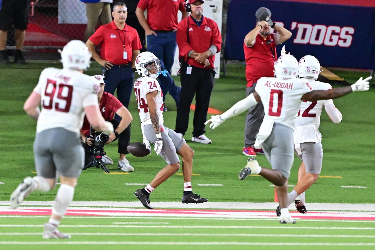 Washington State defensive back Ethan O’Connor looks back to celebrate after he intercepted a Fresno State pass and returned it for a touchdown during the second half Saturday in Fresno, Calif.  (Tyler Tjomsland/The Spokesman-Review)