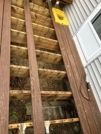 Can you believe the size of the cracks in the top of these treated lumber deck joists? They were hidden by the deck boards that were removed.  (Tim Carter)